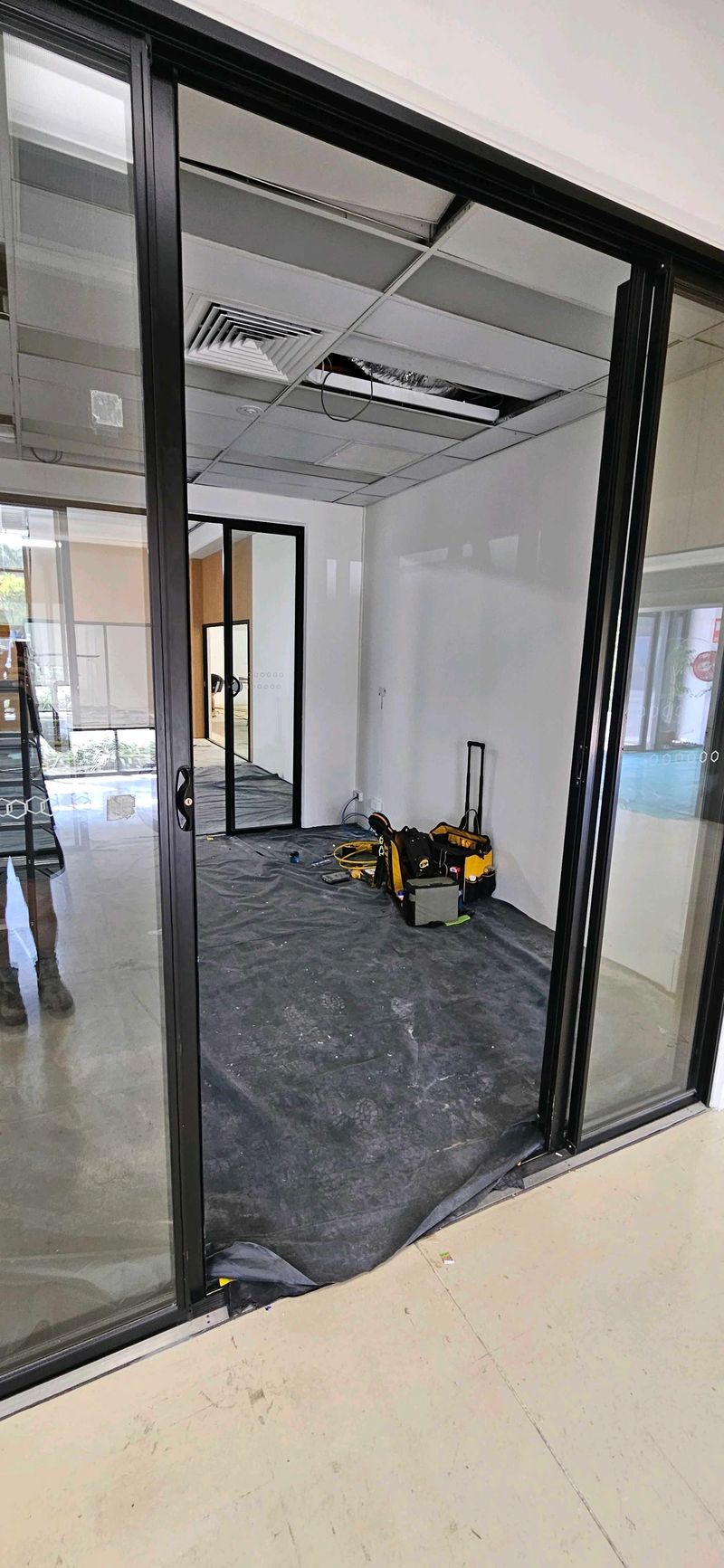 Empty room with glass doors and electronic testing equipment on the floor